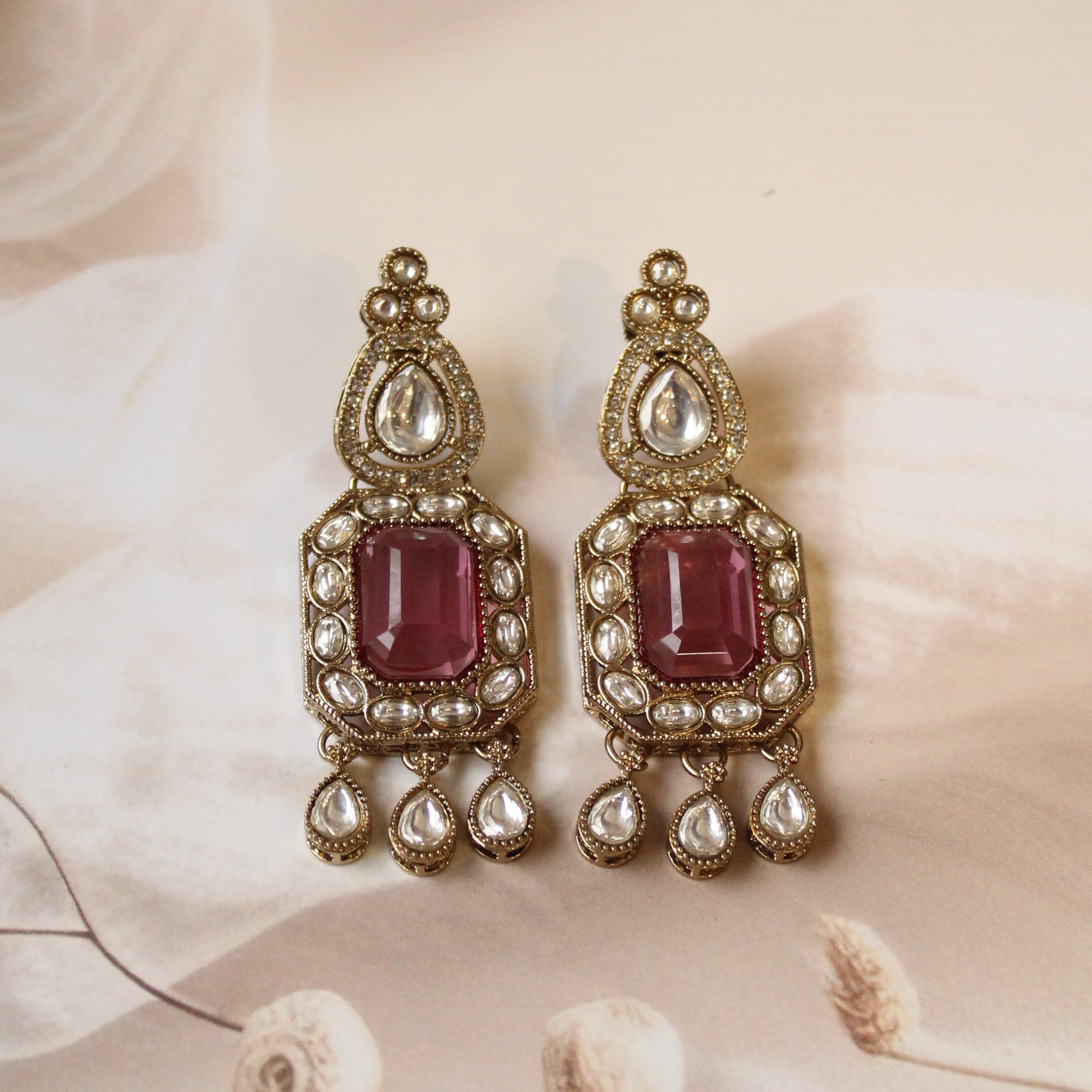 pink tone kundan earrings