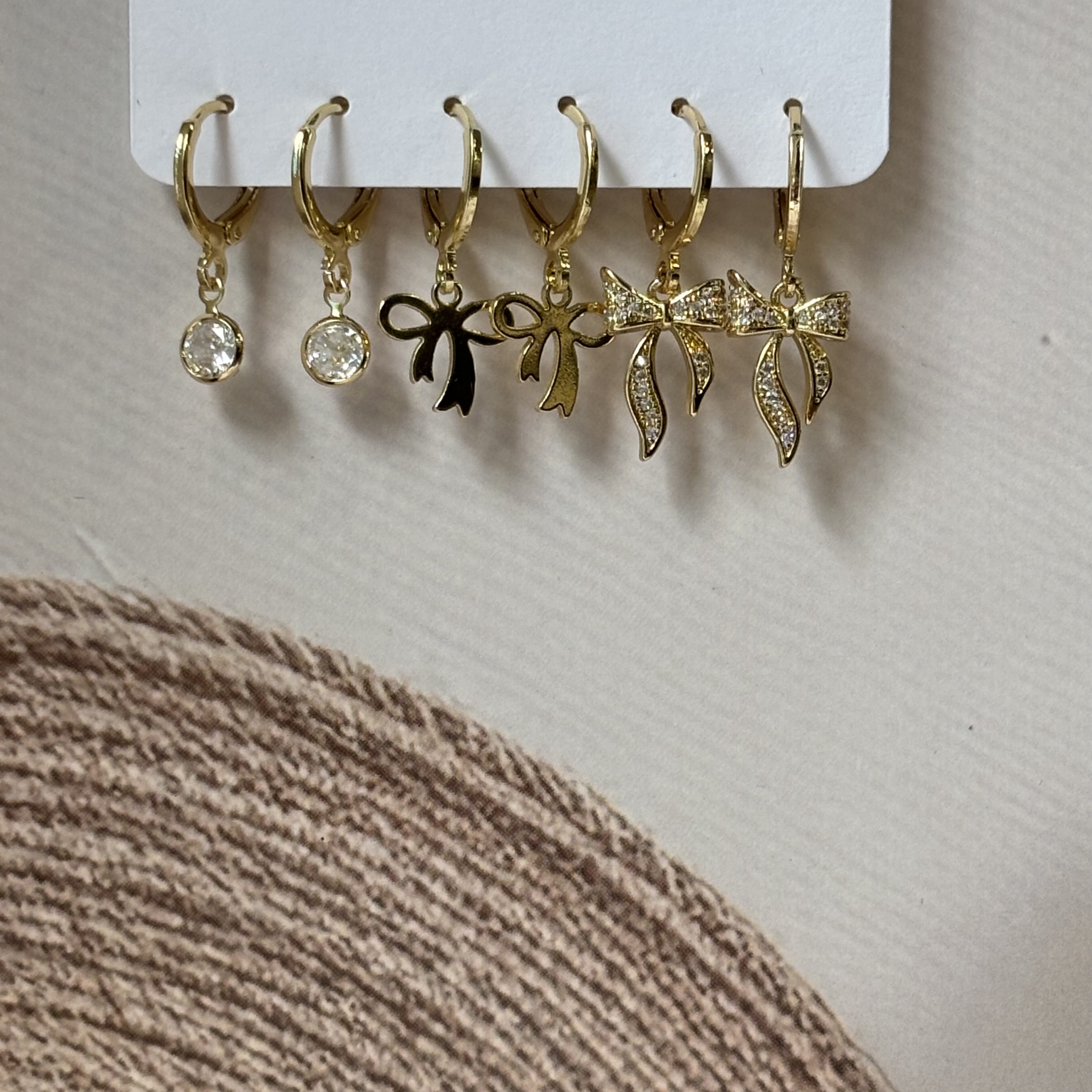 3 pairs of golden earrings- bow